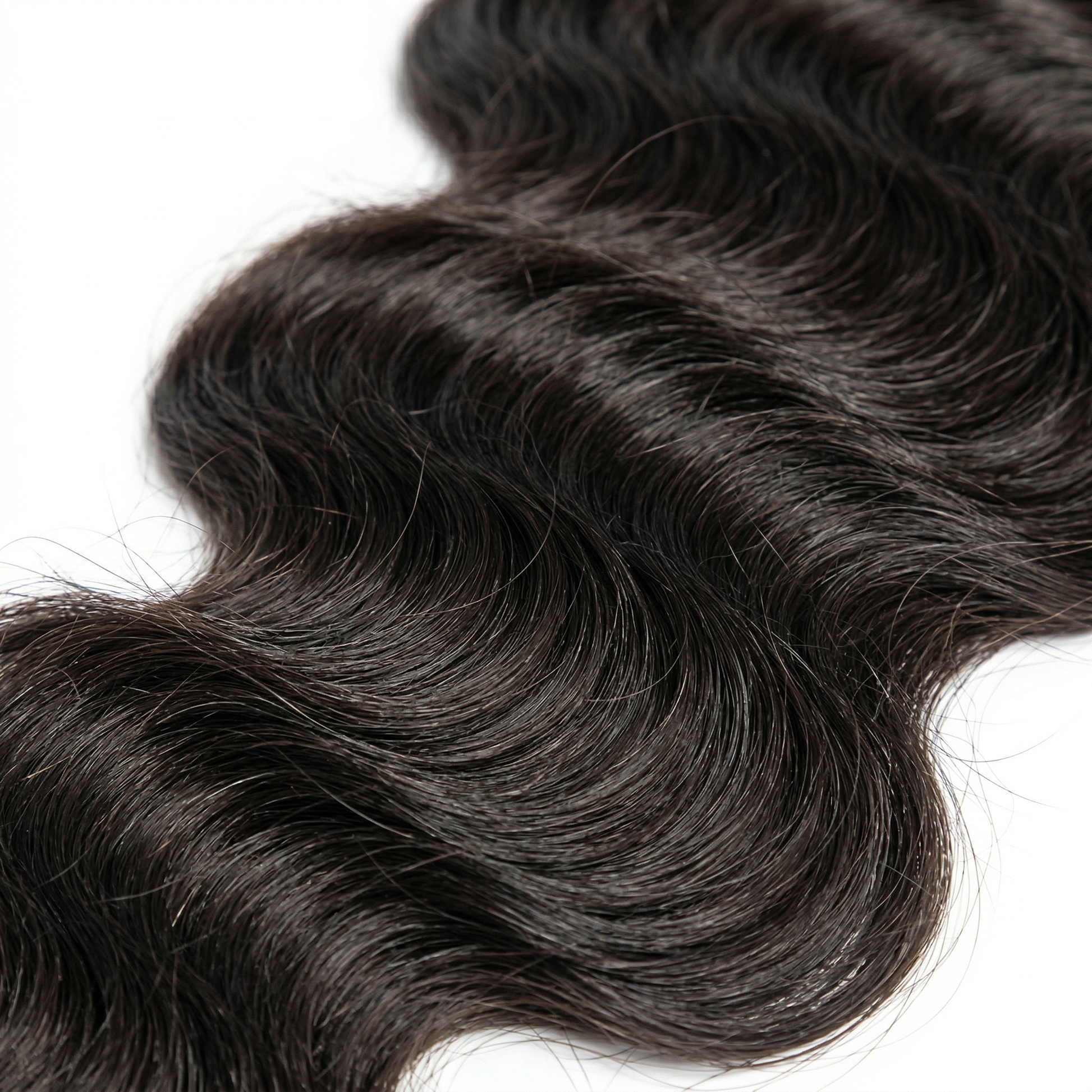 Close-up of dark brown hair extensions on a white background