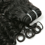 Three bundles of black loose wave hair extensions on a white background